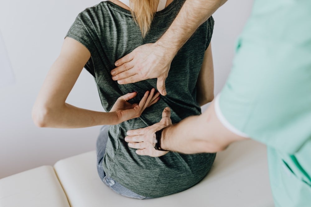 https://www.pexels.com/photo/crop-unrecognizable-woman-showing-chiropractor-painful-spot-on-back-4506109/